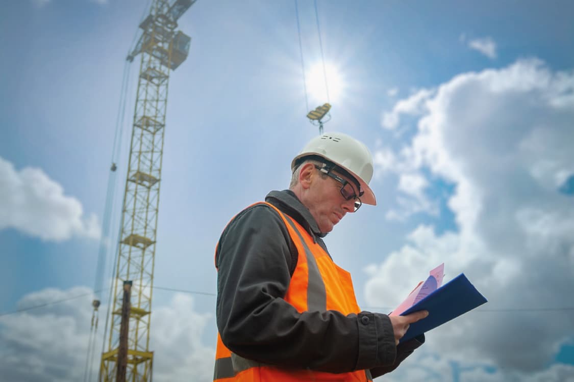 A site supervisor conducting a safety check on a construction site.